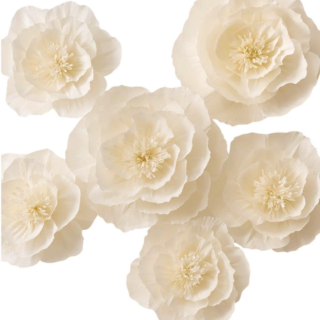 Six cream-colored paper flowers with layered petals and textured centers, perfect for a DIY garland, arranged against a plain white background.